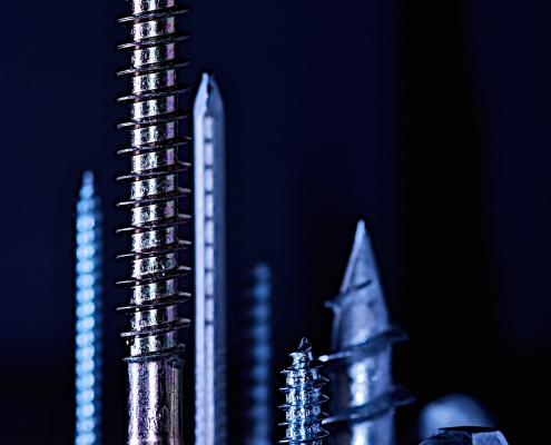 chris-yates-bVG0-KSh8Sc-unsplash Nuts, bolts and screws against a dark background; how to purchase carbon credit - part 1