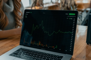 trading; laptop with stock chart and info on screen; market news