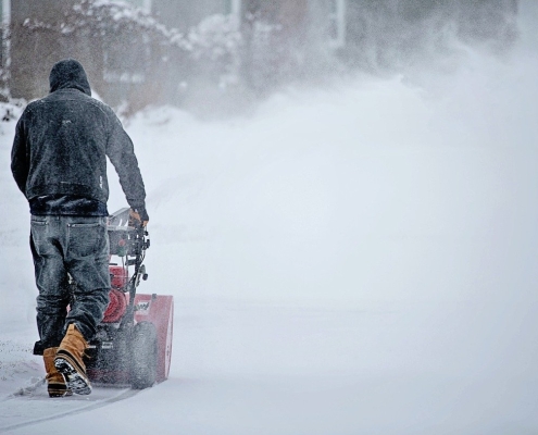 snowblowing-7676129_1280 person with a snowblower