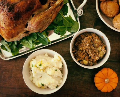 pro-church-media-ZBlGrPvGiHg-unsplash turkey, potatoes, stuffing, pumpkin on a table; Thanksgiving - sharing gratitude