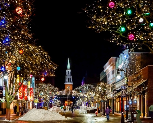 church-648430_1280 image of traditional small town main street lit with Christmas lights with church at the end of the street - connection