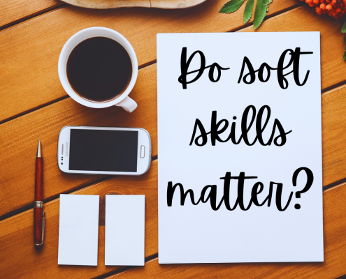 Your paragraph text desktop showing aerial view of full coffee cup, phone, notepad and pen, with white paper that has "Do soft skills matter?" written on it