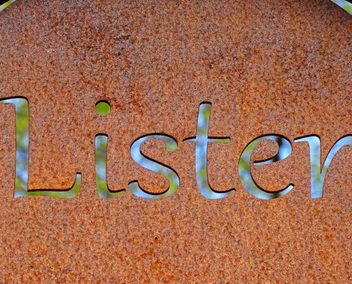 belinda-fewings-Y58fhMLGsrM-unsplash rusted sign with the word listen cut out of it