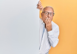 krakenimages-8RXmc8pLX_I-unsplash older man with glasses peaking around corner looking surprised; market news; tariffs