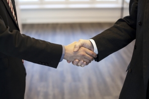 trust-3031679_1280 image of two hands clasped in business dress; demonstrating merging