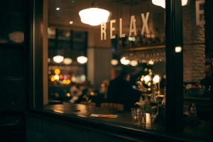 dark-2595778_1280 image of a restaurant through a window with the word relax visible; Chile