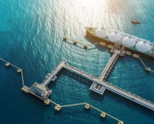 LNG (Liquified Natural Gas) tanker anchored in Gas terminal gas tanks for storage. Oil Crude Gas Tanker Ship. LPG at Tanker Bay Petroleum Chemical or Methane freighter export import transportation and logistics a fuel transport boat at a dock on the water; Westlark Advisors at OPIS NGL Summit