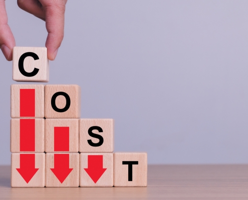 Cost reduction concept. Optimize manufacturing management. Optimization, Strategy, Economic cost savings. Hand puts wooden cube with words cost and green down arrows. cost icon on virtual screen. blocks stacked in descending order like stair steps; the words cost descending stairs on the blocks with red arrows pointing down; Hedging 301 - Financial options - how they are used
