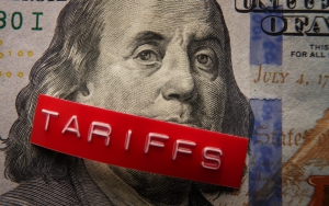 Red Tariffs label on a hundred dollar bill face of Benjamin Franklin from the 100 dollar bill with the word "tariffs" in white letters on a red background across Ben's mouth; current events - tariffs - April 2025; Current Events - July 2025; shifting global oil flow