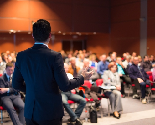 A man speaking at a business conference view of a man presenting something to an audience; Western Propane Trade Show & Convention