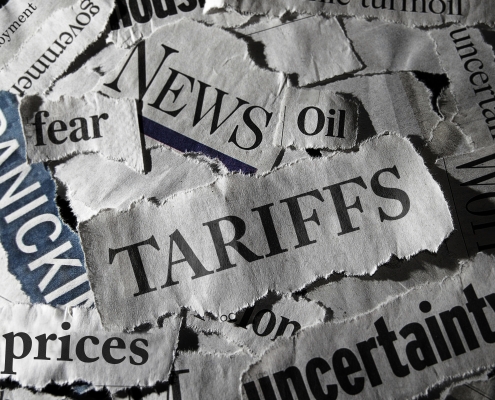 Tariff news headlines newsprint collage with "tariffs" in the middle, "news" above and "uncertainty" below right; global supply shifts
