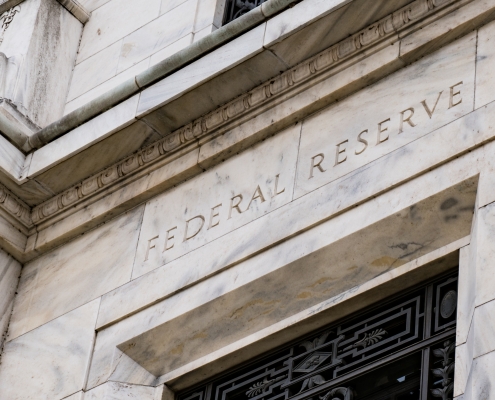 closeup image of the entrance to the Federal Reserve building at an angle; Current Events July 2025; 2026 what to expect energy