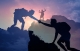 silhouettes of a person helping another person up a hill, overlaid on top of a silhouette of a person standing on top of a hill; rising above