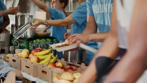 Poor Wheelchair User Receiving Free Food people serving food - fruits and vegetables to people; giving thanks