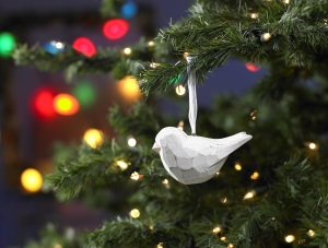 Christmas Where white wooden dove on Christmas tree; peace and hope at Christmas