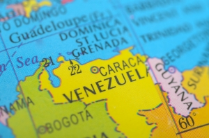 A vibrant political map highlights Venezuela in bright yellow, clearly marking its capital, Caracas, and its strategic position on the Caribbean coast of South America. map of Venezuela with capitol city marked; Iran sanctions, Venezuela regime change