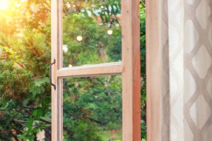 Sunset or sunrise view from window in balcony open glass door at sunrise; hope at Easter