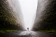 man walking between two high cliffs through hazy fog; hope at Easter