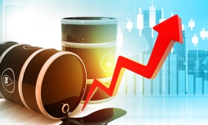 Oil price growth graph concept image oil barrels, one tipped over spilling, with red arrow going up against background of financial graphs; showing rising oil prices; Iran War impact energy prices