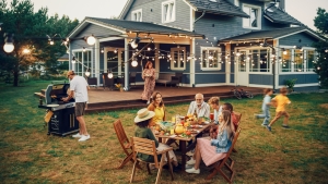 Big Family and Friends Celebrating Outside at Home. Diverse Group of Children, Adults and Old People Gathered at a Table, Having Fun Conversations. Preparing Barbecue and Eating Vegetables. family and friends enjoying backyard bbq, party; Memorial Day Honor and Remebering
