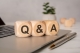 wooden blocks on a laptop spelling Q & A