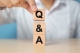 person stacking blocks saying "Q&A"
