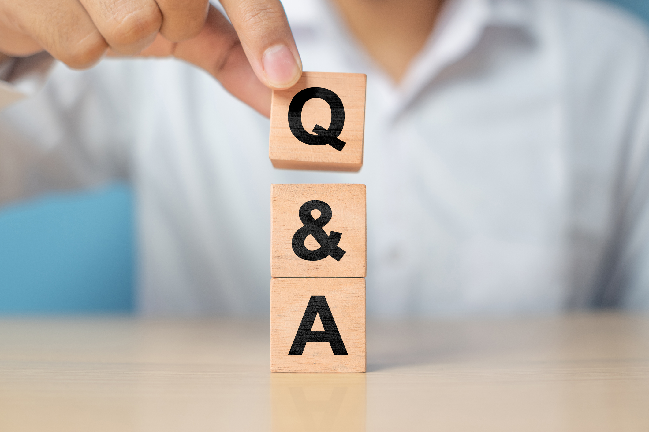 person stacking blocks saying "Q&A"