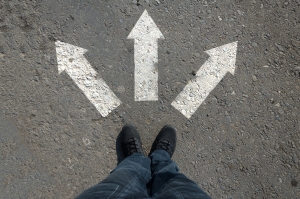 road split black shoes on road with 3 white arrows pointing in different directions; Bangaldesh LPG changing routes